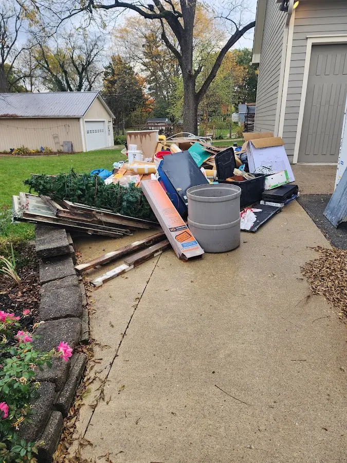 Dumpster being loaded with debris for 12 Yard Dumpster Rental in Walpole